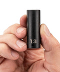 Hand holding Bad Boy 1/4 Inch Drive Six Point Impact Socket 13 Millimeter showing clear laser markings.