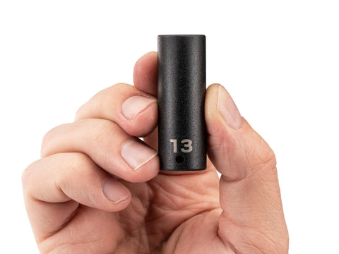 Hand holding Bad Boy 1/4 Inch Drive Six Point Impact Socket 13 Millimeter showing clear laser markings.