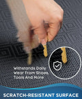 Demonstration of Ultra Thick Anti Fatigue Floor Mat For Kitchen And Office Three Quarters Inch Cushioned 20 By 39 Inch Rug Waterproof Non Slip Ridged Bottom Ergonomic Standing Mat For Long Hours At Home And In The Office, showing scratch-resistant surface with keys.