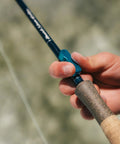 User gripping Mag Grab Rod Rack Magnetic Fishing Rod Holder Black Quick-Access One-Hand Mount for easy lure changes.