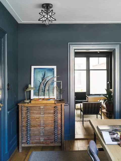 Moravian Star Flush Mount Ceiling Light in black iron with seeded glass shade in a modern living space, easy hardwired install.