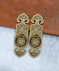 Two Pack Vintage Style Embossed Brass Drawer Pulls for Wardrobe Bookcase and Double Doors in antique bronze finish on wood surface