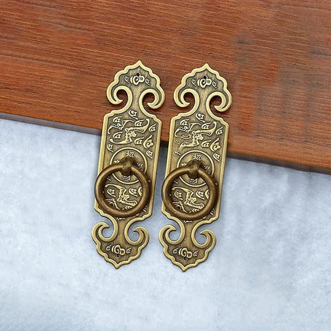 Two Pack Vintage Style Embossed Brass Drawer Pulls for Wardrobe Bookcase and Double Doors in antique bronze finish on wood surface