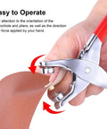 Using 1203Pcs Grommet Eyelet Pliers Tool Kit With 1/4 Inch Eyelets And Washers on fabric; close-up view of pliers in hand