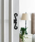 Premium Four Pack Carbon Steel Barn Door Hinge Hardware In Matte Black, shown installed on a white door frame.