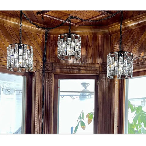 Three plug in vintage crystal pendant lights with chain, black metal frame, dimmable K9 crystal beams, in a wooden room setting.