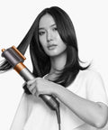 Model using Airwrap Origin Multi Styler With No Heat Damage, 1.2 Inch Barrel, for smooth, voluminous hair styling.