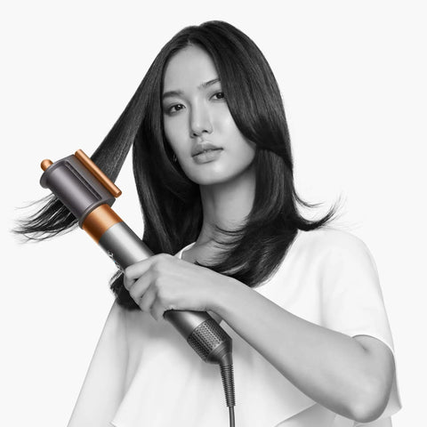 Model using Airwrap Origin Multi Styler With No Heat Damage, 1.2 Inch Barrel, for smooth, voluminous hair styling.