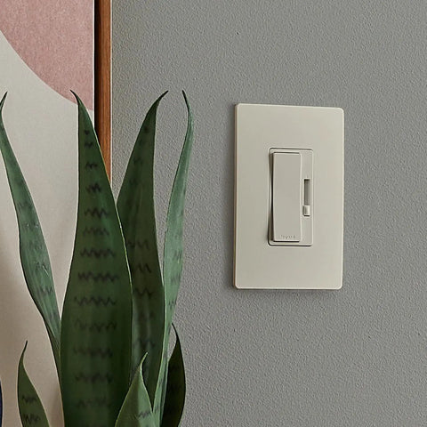 Heavy Duty 150 Watt Led Dimmer Switch 3 Way Rocker Control Brightness Adjustment For Dimmable Bulbs Smooth Flicker Free Operation Built To Last Easy Hookup Almond Finish mounted on a wall with plant.