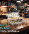 Open box of All In One 420 Piece Drywall Anchors Kit with self drilling metal plugs on a workbench