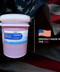 Kick Ass Heavy Duty Low Foam Auto Floor Cleaner Industrial Strength Concentrate in 5-gallon container on American flag backdrop.