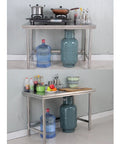 Heavy Duty 304 Stainless Steel Work Table With Adjustable Height And Removable Top For Commercial Kitchen Or Shop Space, equipped with cooking pots and groceries.
