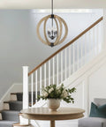 23 Inch 5 Light Modern Farmhouse Rustic Armillary Pendant Chandelier With Sphere Orb In White Ash Wood Finish And Galvanized Steel Finish perfectly hung in a stairway entrance.