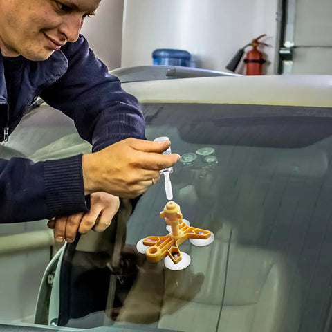 Man using Windshield Chip Repair Kit for Quick Fix and Crack Stop Auto Glass Repair Tool on car windshield