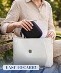 Person placing Purple 6 Slot Peptide Vial Storage Case For 3ml 10ml 30ml Bottles into white bag on park bench