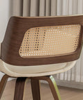 Close-up of backrest on set of 2 swivel dining chairs with curved arms, ergonomic cane back, bentwood frame in walnut beige