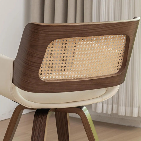 Close-up of backrest on set of 2 swivel dining chairs with curved arms, ergonomic cane back, bentwood frame in walnut beige