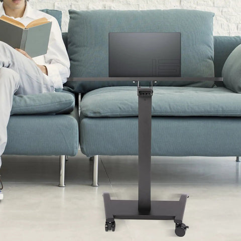 Height Adjustable Standing Desk Podium With No Sweat Foot Pedal And Smooth Roll Casters For Teachers Ergonomic Mobile Lecture Stand with laptop next to person on couch.