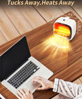 Tiny Yet Mighty Space Heater 2 Pack White 1200W PTC Fast Heating With Overheat And Tip Over Protection on desk near laptop