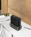 Heavy Duty 28 Piece Metal Transfer Punch Set With Sturdy Alignment Base displayed on a table with measuring tape.