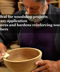 Person applying Straight Up Top Shelf Refined Walnut Oil For Wooden Kitchen Items And Cutting Boards 9 Fl Oz on a wooden bowl.