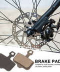 Mountain Bike Disc Brake Pads, 4 Pairs, Lightweight Semi Metallic Replacement Kit For Hydraulic Systems shown on wheel.