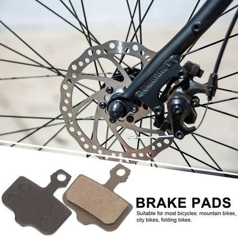Mountain Bike Disc Brake Pads, 4 Pairs, Lightweight Semi Metallic Replacement Kit For Hydraulic Systems shown on wheel.