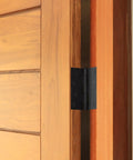 Four Inch Matte Black Interior Door Hinges Value Pack With Three Heavy Duty Leaves Pre Lubricated For Dead Silent Swing, shown on a wooden door.