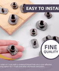 Solid As A Rock M10 T Shaped Weld Nuts 10 Piece Black Carbon Steel Tab Fasteners With UNC Threads And Four Millimeter Projection hand-held, showing detail on a wooden surface.