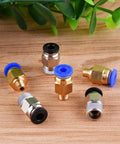 Front view of 6 brass pneumatic push-fit fittings with blue and black seals for PTFE tubing, on wood surface