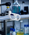 Close-up of white plastic Adjustable Tubing Clamps 10 Pack For Quarter To Half Inch Tubing With Easy Flow Control in lab setting
