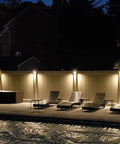 Night view of backyard deck with 12 Pack LED Low Voltage Deck Lights illuminating chairs and fence, 3000K warm white