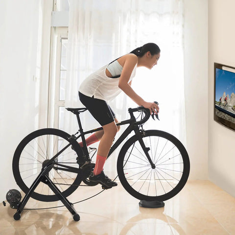 Woman cycling on Magnetic Bike Trainer Stand For Indoor Cycling And Home Gym Use Foldable Stationary Bicycle Roller