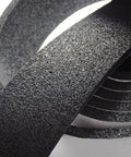 Close-up of Pipe Insulation Foam Wrap Tape Self Adhesive With High Resilience, textured black surface, coiled arrangement