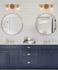 Two Light Gold Vanity Lighting Fixture With Globe Seeded Glass Shades For Bathroom over navy blue vanity cabinets
