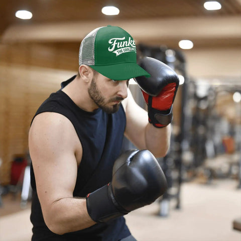 Man boxing in gym wearing Cool Uncle Club EST 2026 Like A Dad But Cooler Green Trucker Hat