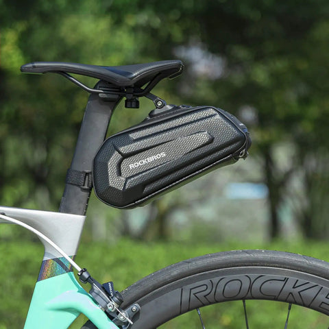 Under Seat Bike Saddle Bag With 3D Hard Shell And Quick Release 1.7L Capacity Silver Reflective Strip For Mountain And Road Bikes With Tons Of Room For Tools Lights Phone Gloves And More attached to bike.