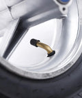Close-up of valve on rear wheel tire with bearings for 49cc mini pocket rocket bike 110/50-6.5, 3.94 inch wide tubed tire hub rim black
