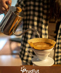 Pouring water into an unbleached coffee filter cone in a white dripper, using Rock Solid Pack Of Unbleached Number Four Cone Coffee Filter Papers 200 Count Fits 8 To 12 Cup Drip Brewers For Ninja Makers Smooth Daily Sip Everyday Essential.