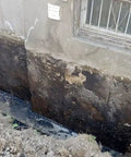 Foundation wall showing moisture damage needing Kickass Rubberized Waterproofing Sealant For Foundations And Flat Low Slope Roofs Concrete Wood Metal Black Five Gallon Multi Purpose Coating Built Damn Tough For Blazing Heat Or Freezing Cold With Knockout Flexibility For Serious Indoor Outdoor Repairs.