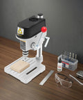 Genseino 340W Mini Bench Drill Press With 110V Power and Fast Three Speed Controls on workbench with wood and tools