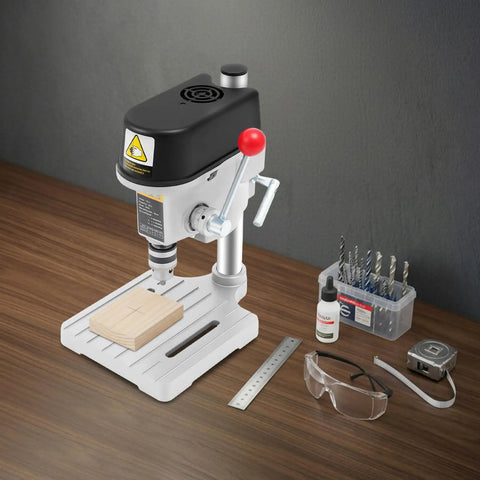 Genseino 340W Mini Bench Drill Press With 110V Power and Fast Three Speed Controls on workbench with wood and tools