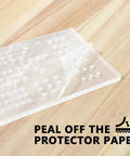 Clear Acrylic Cribbage Board Template Kit With Twelve Colorful Counting Pegs For Game Night Essentials with protective paper being peeled off.