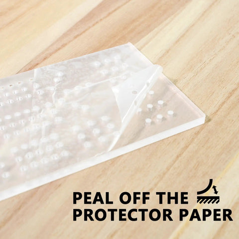 Clear Acrylic Cribbage Board Template Kit With Twelve Colorful Counting Pegs For Game Night Essentials with protective paper being peeled off.