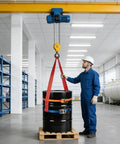 Shop Floor Ready Heavy Duty Fifty Five Gallon Drum Lifting Sling With Twin Adjustable Ratchet Straps during overhead lift by worker.