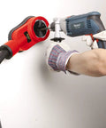 Universal Drilling Dust Shroud With Vacuum Suction For Three Eighths To Two And Five Eighths Inch Holes in use on wall