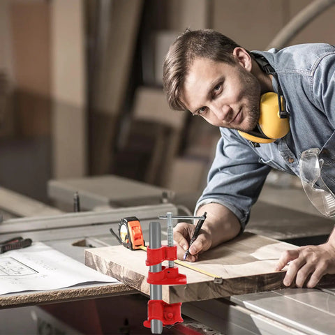 Carpenter using Lightweight Three Quarters Inch Quick Woodworking Pipe Clamp for wood gluing on a wooden board in a workshop.