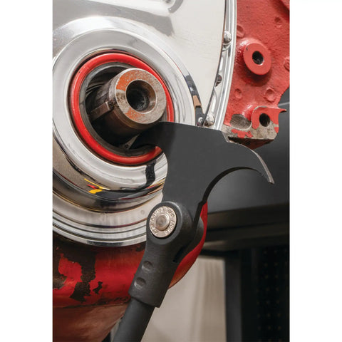 Close-up of indexing twin hook oil and grease seal puller with 14 locking positions removing a seal from metal housing