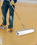 Worker using Spiked Roller For Self Leveling Concrete Floors, 20 Inch Total Length, 18 Inch Spiked Section, 21mm Needles