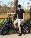 Man riding Ranger Two Point Zero Fat Tire Electric Bike For Adults with 1400W Peak Power and 20 Inch Step Through Frame in park